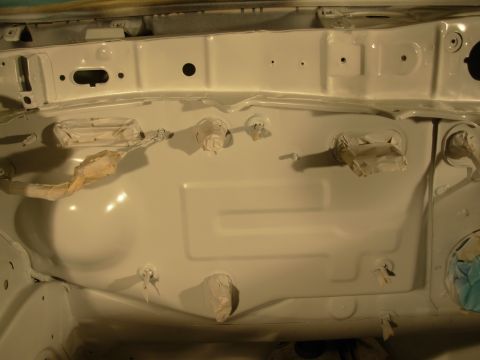 1991 Ford Taurus - The engine bay of a vehicle is shown after being painted white, with various components taped off.