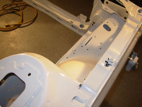1991 Ford Taurus - Close-up of a car's frame undergoing restoration work, showing structural components.