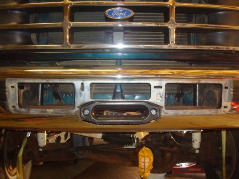 1995 Ford Bronco - Close-up of a Ford Bronco's front end, showing the grille, bumper, and an installed winch.