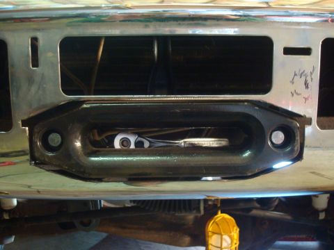 1995 Ford Bronco - Close-up of a winch fairlead with a ratchet tool visible inside.