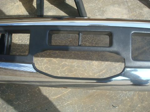 1995 Ford Bronco - Detail of a vehicle's front bumper, showing a section of the grille and chrome trim.