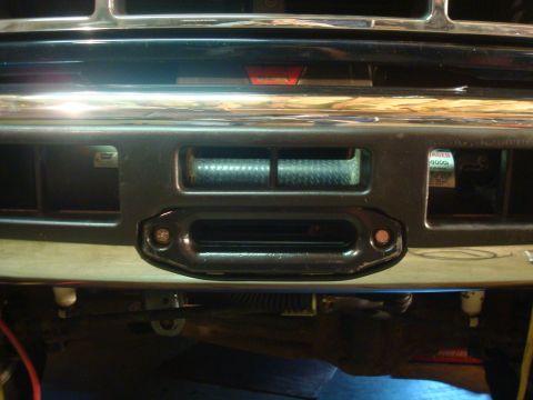 1995 Ford Bronco - Close-up of a vehicle's front bumper, showing a winch and tow hook assembly.