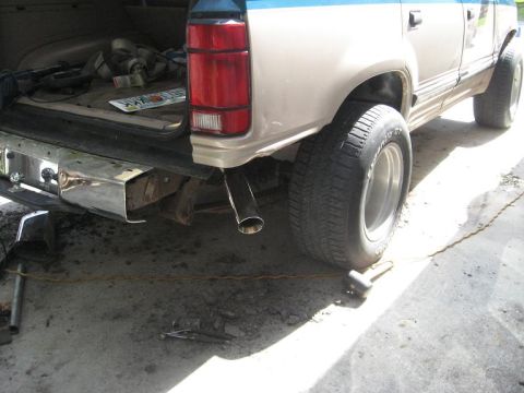1992 Ford Explorer - Rear view of a beige and blue SUV with a chrome bumper and aftermarket exhaust.