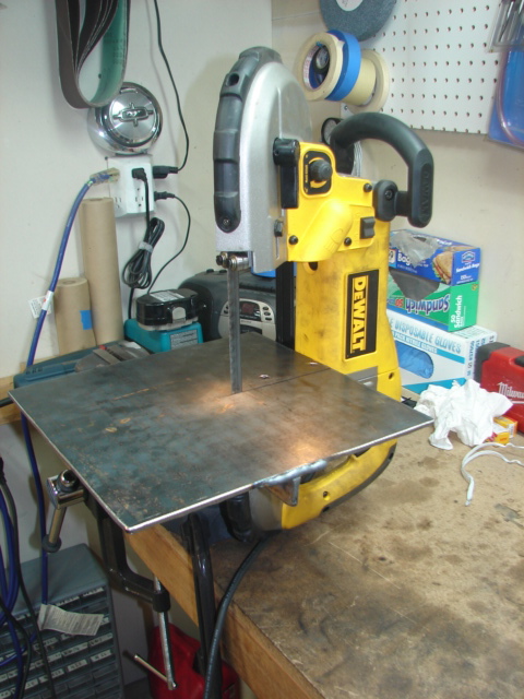 1996 Ford Bronco - A DeWalt band saw is set up on a workbench, ready for use.