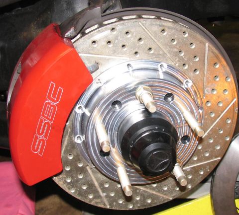 1990 Chevrolet Silverado 1500 - Close-up of a red SSBC brake caliper and a drilled rotor, indicating performance upgrades.