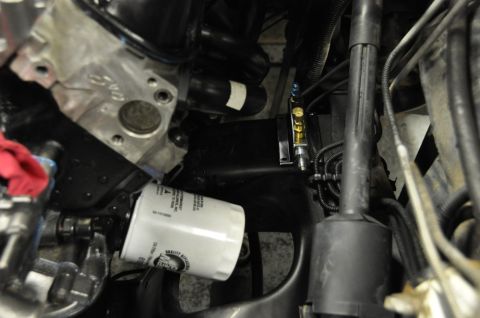 1996 Ford Bronco - Close-up view of an engine oil filter and surrounding engine components.
