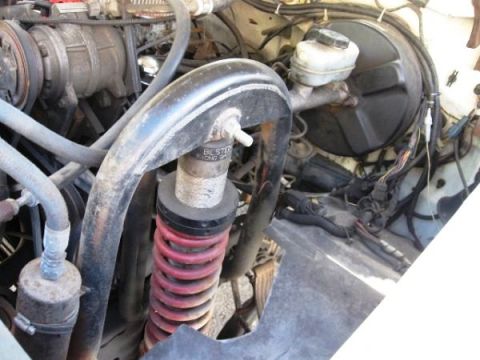 1986 Ford Bronco - Engine bay detail a red coilover shock absorber with visible Bilstein branding.