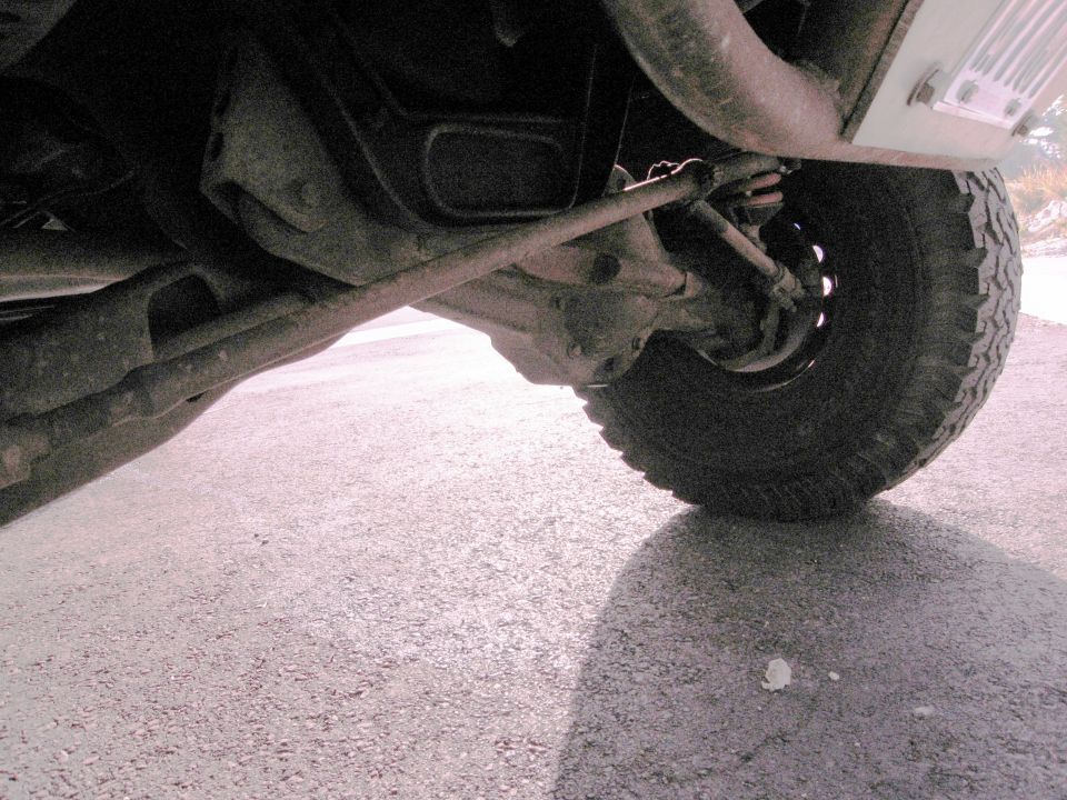 Undercarriage of a vehicle showing suspension and tire