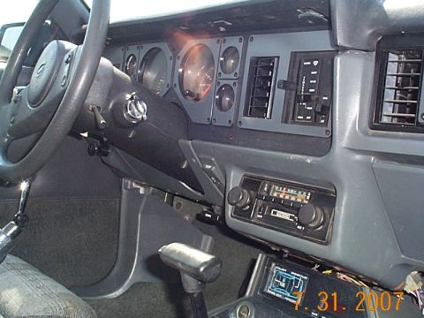 1984 Ford Mustang - Interior view of a 1984 Ford Mustang, the dashboard, steering wheel, and center console.