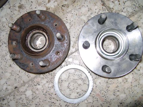 1998 Ford Crown Victoria - Comparison of a new and old wheel hub assembly, along with an ABS sensor ring.