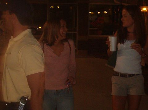 1998 Ford Taurus - People gathered outdoors at night, with one person holding a beverage.