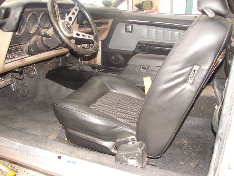 1973 Ford Ranchero - The interior of a 1973 Ford Ranchero shows black seats and a dashboard.
