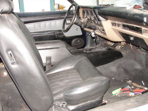 1973 Ford Ranchero - Interior view of a 1973 Ford Ranchero, including the seats, dashboard, and floor.