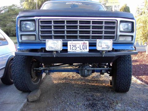 1980 Ford Bronco - Front view of a blue Ford Bronco with an aftermarket bumper and large tires.
