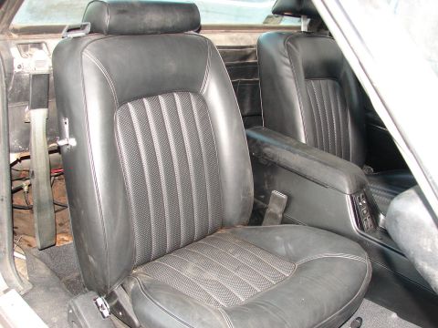 1973 Ford Ranchero - Interior view of black leather bucket seats and a center console, showing the condition of the vehicle's cabin.