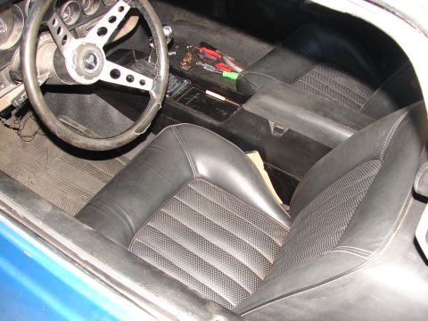 1973 Ford Ranchero - Interior view of a 1973 Ford Ranchero, black vinyl seats and a steering wheel.