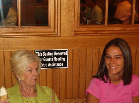 1998 Ford Taurus - A sign indicating reserved seating is visible between two women seated in a booth.