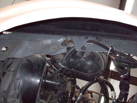 1996 Ford Bronco - Underside view of engine bay components, including brake booster and hydraulic lines.