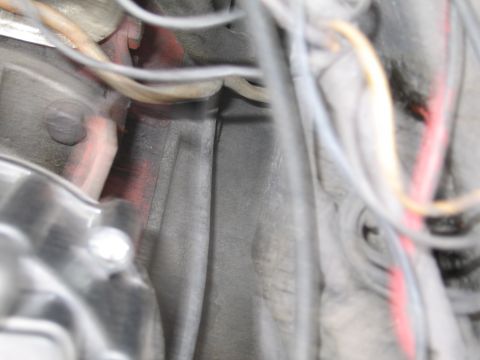 1991 Ford LTD Crown Victoria - A close-up view of the engine bay reveals a tangle of wires and various metal parts, with some red accents visible.