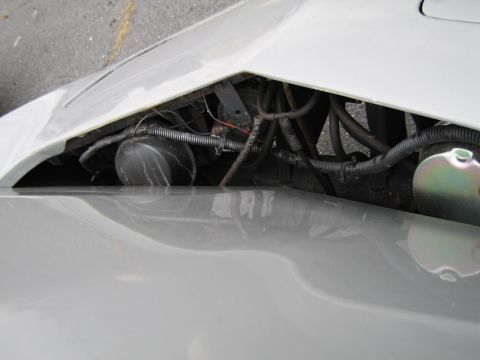 1991 Ford LTD Crown Victoria - Close-up view of engine compartment components in a white vehicle.