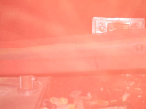 1991 Ford LTD Crown Victoria - A close-up view of a clear plastic component, possibly a light cover or fuse box, with a visible screw, suggesting it is part of a vehicle'…