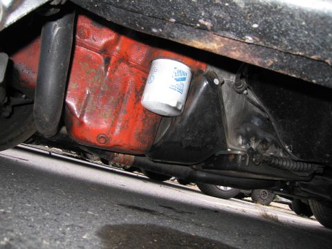 1991 Ford LTD Crown Victoria - Underside view of a vehicle's oil pan and oil filter, showing engine components.