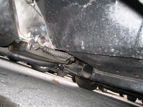 1991 Ford LTD Crown Victoria - The undercarriage of a vehicle, revealing brake lines and exhaust components.