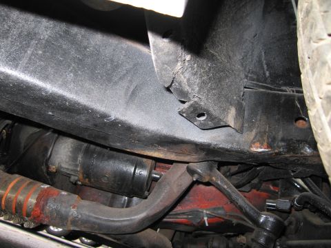 1991 Ford LTD Crown Victoria - Close-up view of the vehicle's undercarriage, revealing mechanical parts and frame structure.
