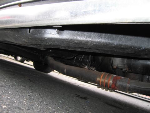 1991 Ford LTD Crown Victoria - A low-angle shot shows the underside of a vehicle, focusing on the exhaust system and frame.