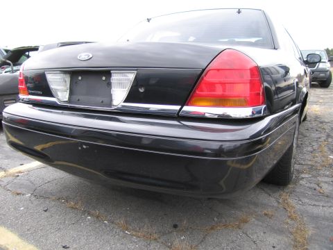 1991 Ford LTD Crown Victoria - Rear view of a black 1991 Ford Crown Victoria LTD, with another vehicle in the background.