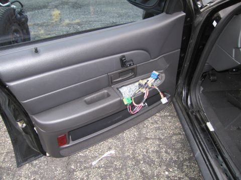 1991 Ford LTD Crown Victoria - Interior view of a car door with wiring harness exposed after trim removal.