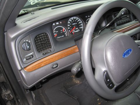 1991 Ford LTD Crown Victoria - Interior view of a 1991 Ford Crown Victoria LTD, showing the dashboard, steering wheel, and wood trim accents.
