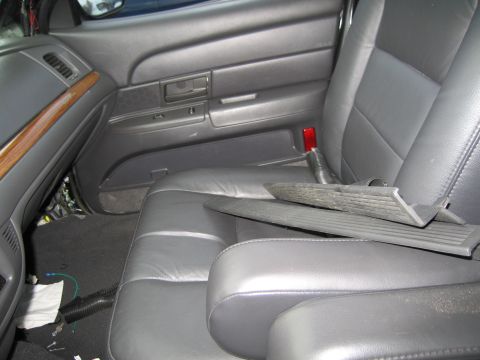 1991 Ford LTD Crown Victoria - Interior view of a 1991 Ford Crown Victoria LTD, highlighting the gray leather seats and dashboard details of the dashboard with wood trim.