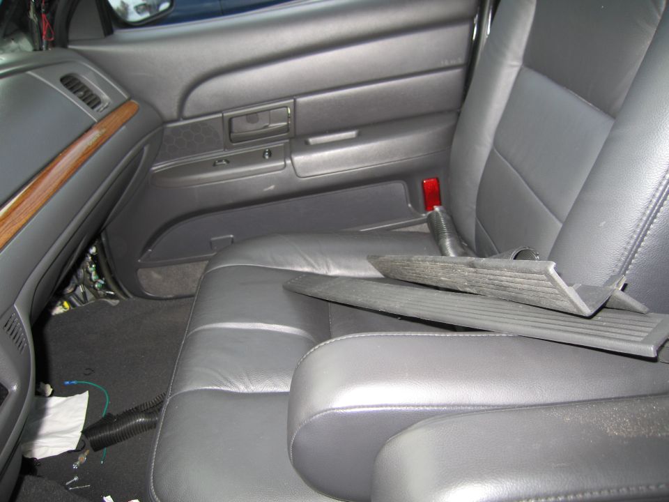 1991 Ford Crown Victoria LTD interior showing gray leather seats, wood trim on the dashboard, and exposed wiring under the dash