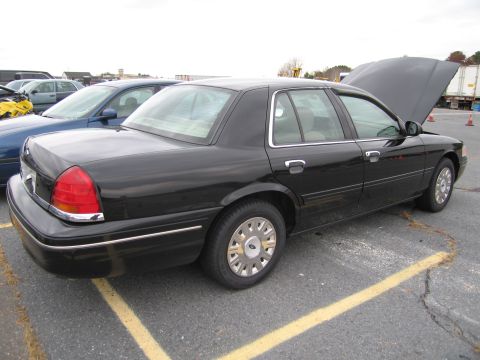 1991 Ford LTD Crown Victoria - Black 1991 Ford Crown Victoria LTD with hood open, parked in a lot next to another vehicle.