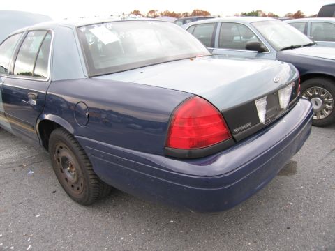 1991 Ford LTD Crown Victoria - Rear view of a police car, showing its taillight and bumper. Another police car is visible to the right.
