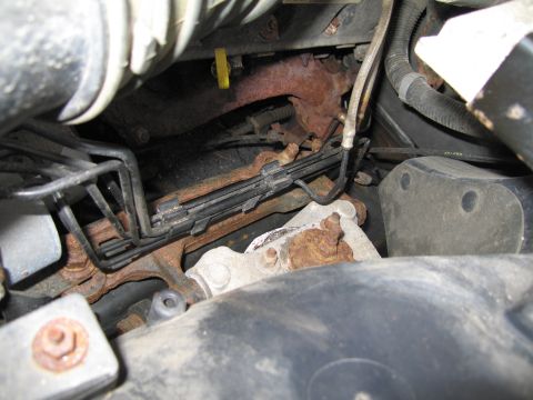 1991 Ford LTD Crown Victoria - Rusted engine components and brake lines are visible in this close-up engine bay view.