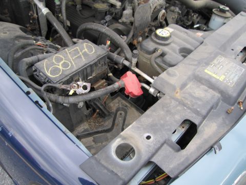 1991 Ford LTD Crown Victoria - Close-up view of a vehicle's engine bay, highlighting the fuse box and battery connections. The fuse box has handwritten markings.
