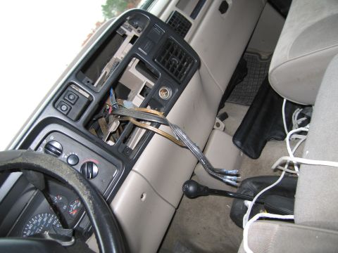 1991 Ford LTD Crown Victoria - The interior of a car shows a disassembled dashboard with wires exposed and a floor shifter visible.