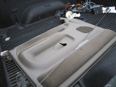 1991 Ford LTD Crown Victoria - A car door panel is shown in the bed of a pickup truck with various electrical components.