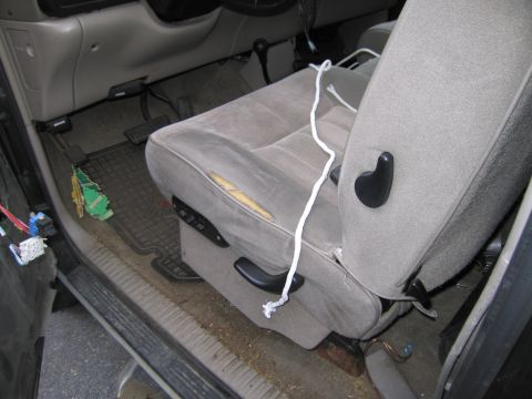 1991 Ford LTD Crown Victoria - Interior view of a car with a damaged seat and visible wiring near the door.