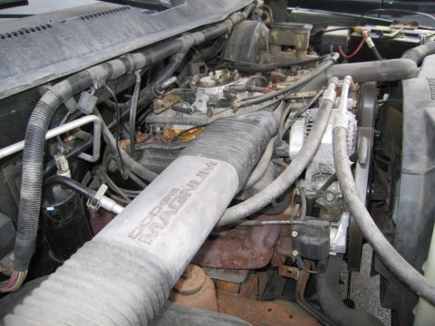 1991 Ford LTD Crown Victoria - Close-up of an engine bay, a prominent "DODGE MAGNUM" air intake tube and engine components.