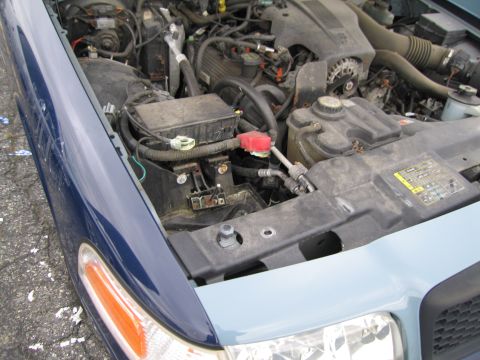1991 Ford LTD Crown Victoria - Engine bay of a 1991 Ford Crown Victoria LTD, showing various components under the hood.