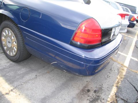 1991 Ford LTD Crown Victoria - Rear view of a blue sedan, showing the taillight and bumper detail.