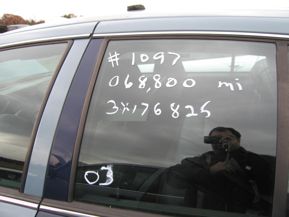 car window with writing: # 1097, 068,800 mi, 3x176825, and 03