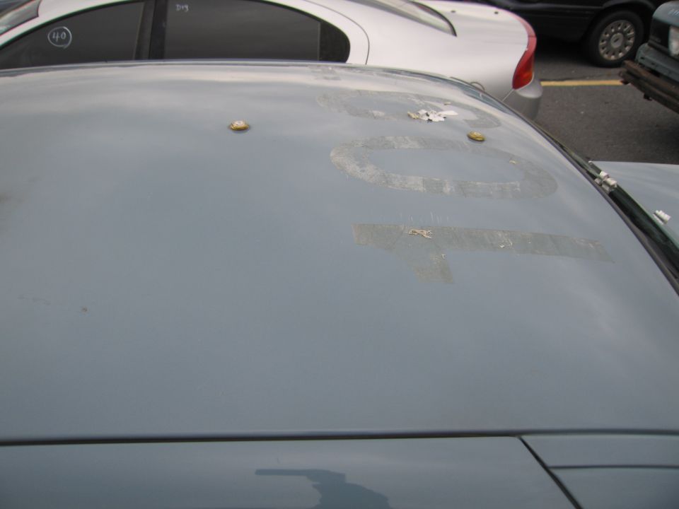 Car roof with faded numbers and two gold studs