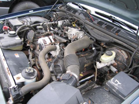 1991 Ford LTD Crown Victoria - A close-up view of the engine compartment, showing various mechanical parts and wiring.