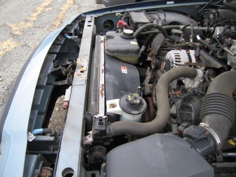 1991 Ford LTD Crown Victoria - Close-up of a car's engine bay, showing the radiator and various hoses.