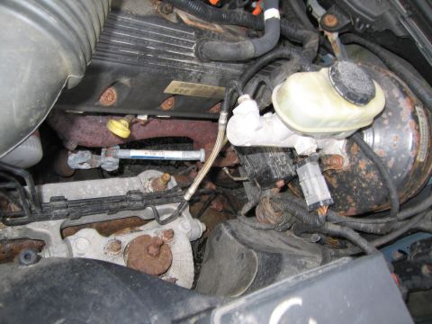 1991 Ford LTD Crown Victoria - Close-up view of the engine bay, focusing on the brake booster and master cylinder assembly.