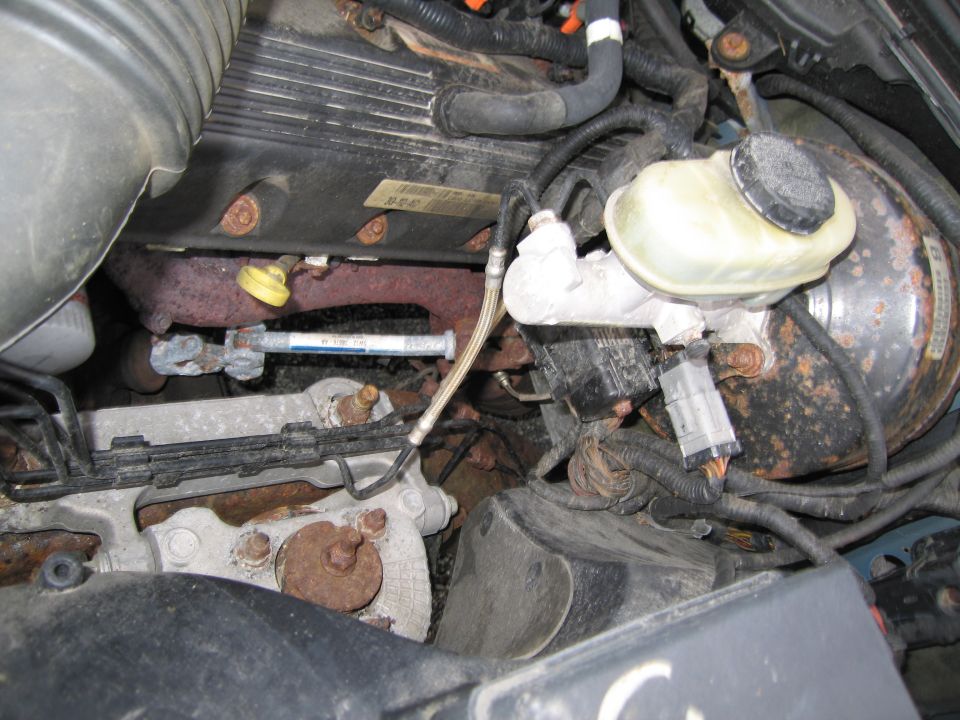 Engine bay showing brake booster, master cylinder, and exhaust manifold